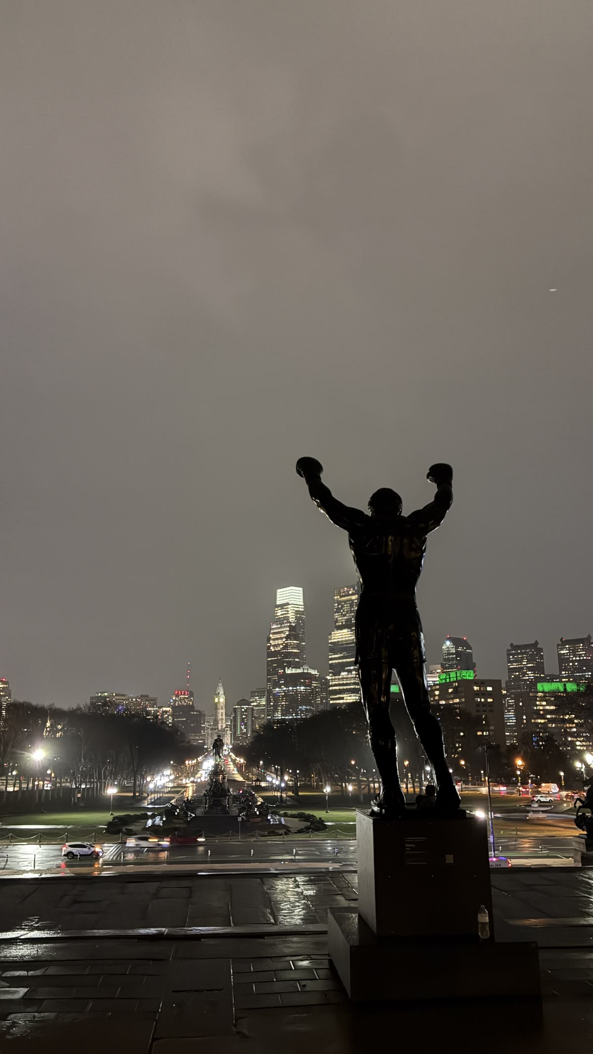 Rocky statue overlooking city lights